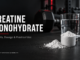 Creatine monohydrate powder in a scoop beside a glass of water and a dumbbell. Benefits, Dosage & Practical Use. Steadfast Strength & Mobility.