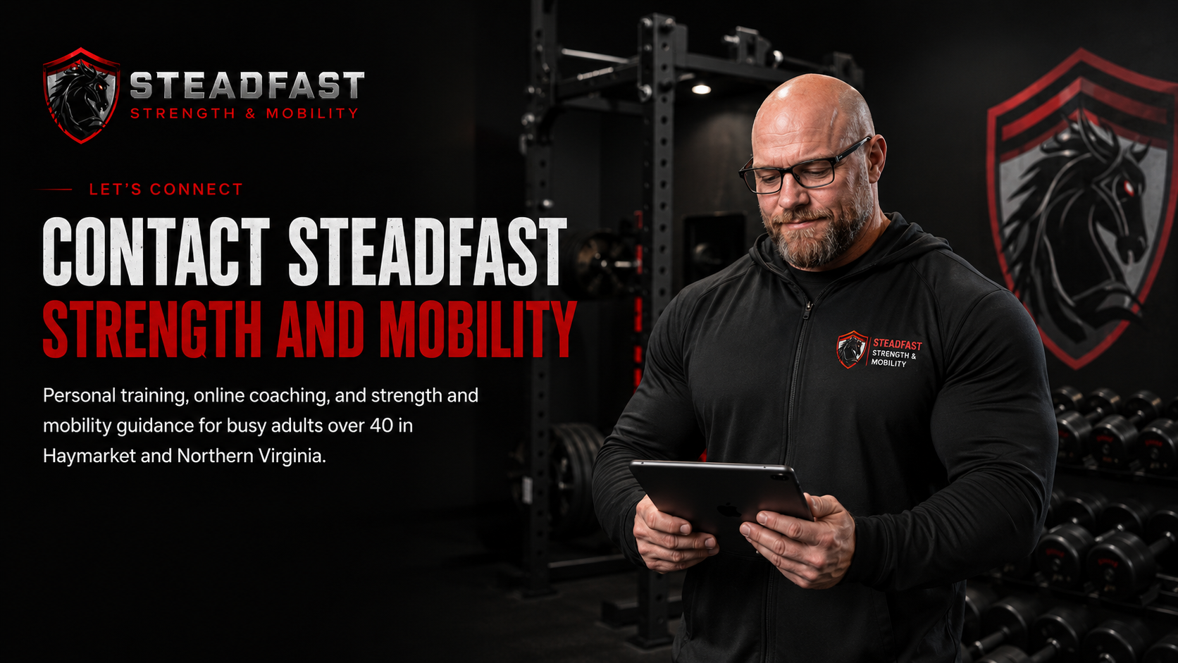 Steadfast Strength and Mobility coach reviewing client information on a tablet in a gym.