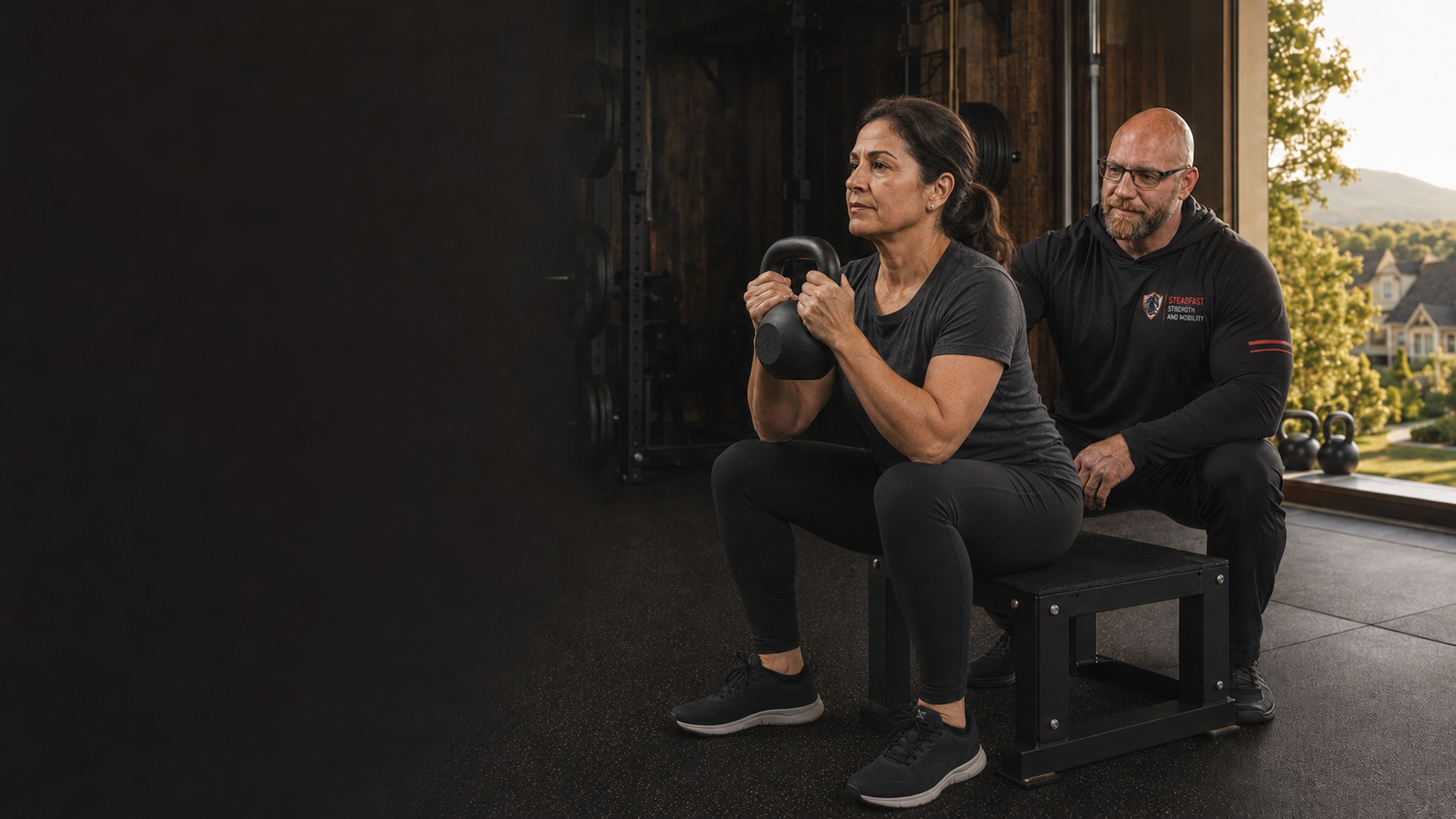 Personal trainer in Haymarket VA coaching a woman over 40 through a controlled kettlebell box squat