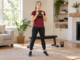Woman holding a kettlebell in a standing goblet position with a bench behind her